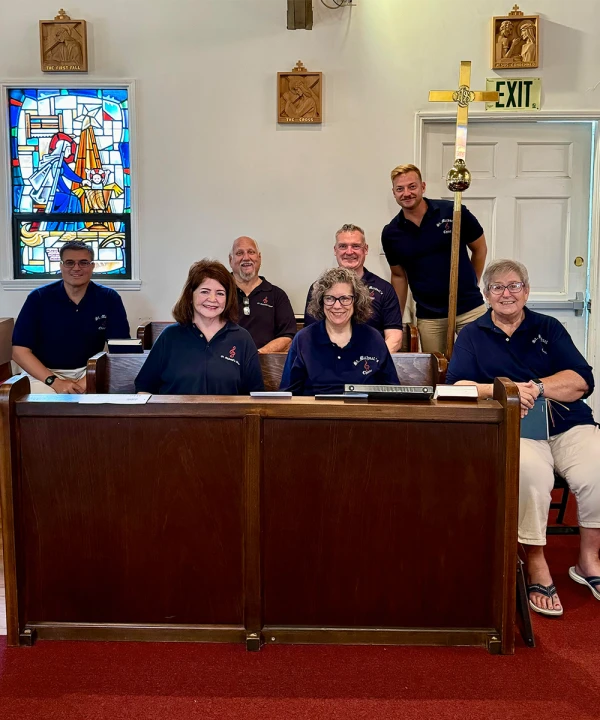 Singers in the choir of St. Michael's pose in the choir stalls.