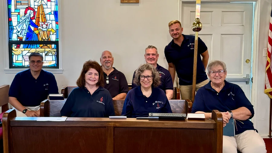 Singers in the choir of St. Michael's pose in the choir stalls.