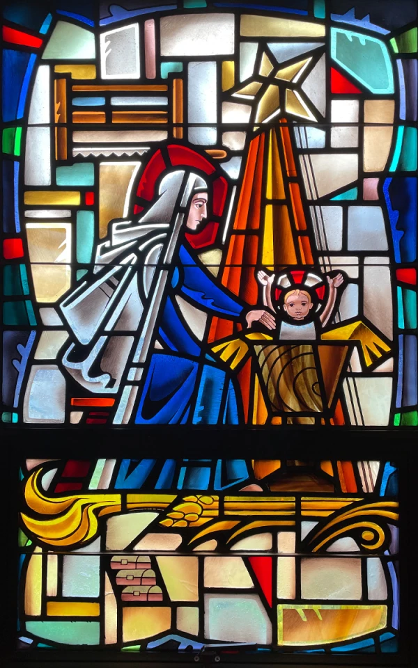 Stained glass window: Nativity scene of Mary and baby Jesus, with a star shining down.