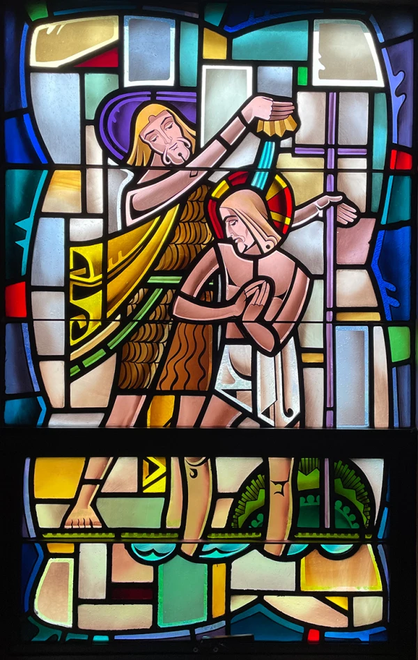 Stained glass window: John the Baptists baptizes Jesus.